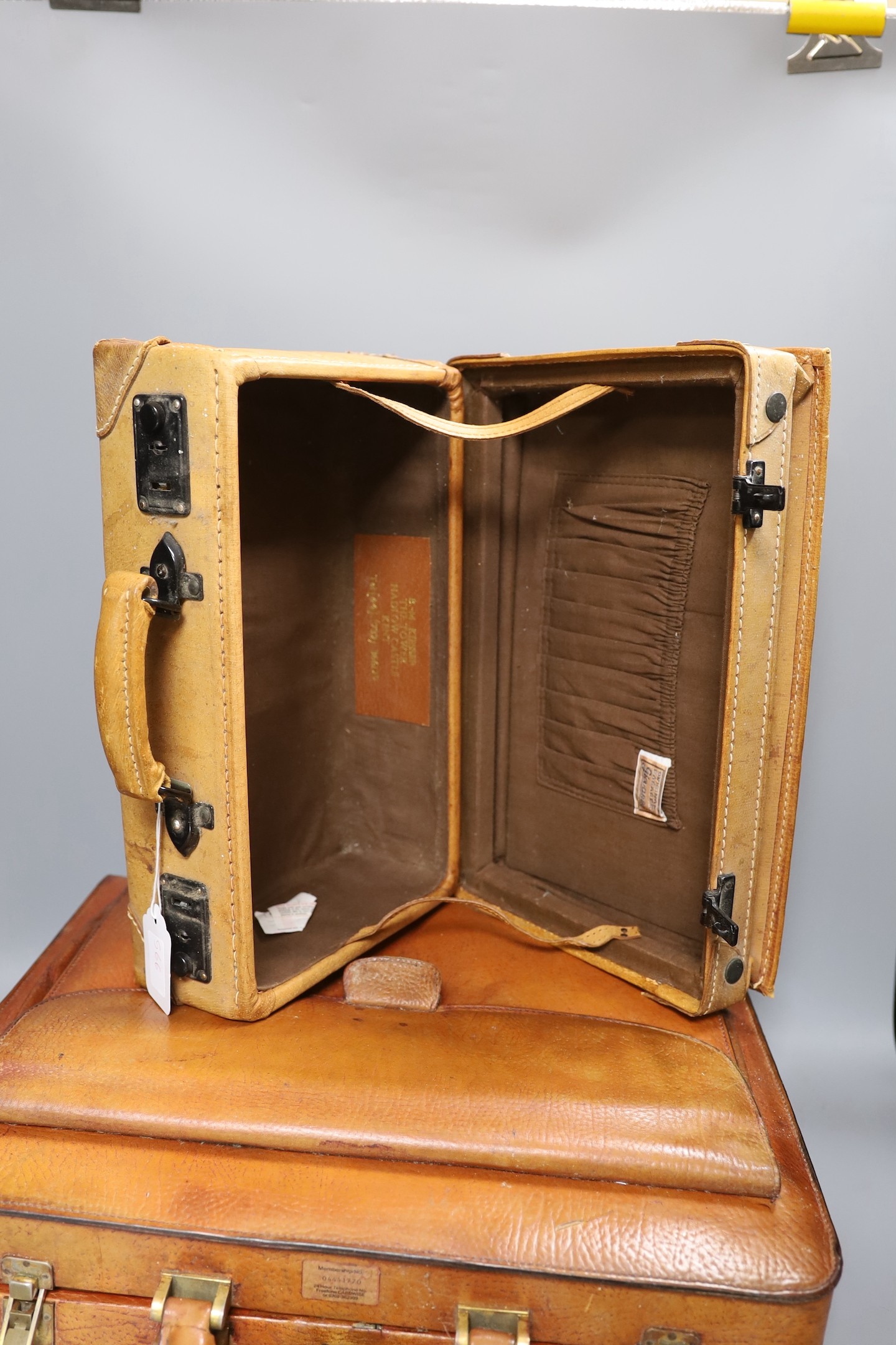 A vintage brown leather briefcase with integrated lock system, together with another Italian Giovanni briefcase